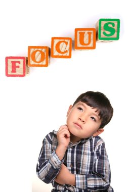 A concept image of a young boy under the word blocks that says focus. clipart
