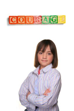 A young student showing couragous pose under word blocks. clipart