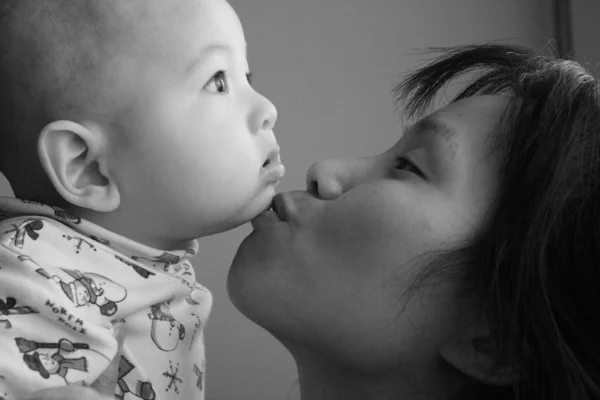 Mother Kisses Baby Son Chin — Stock Photo, Image