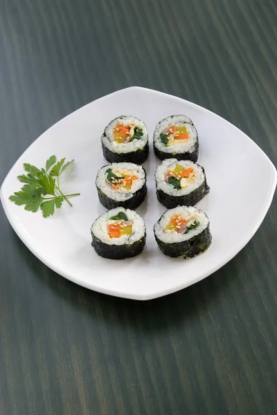 stock image Six pieces of sushi and a parsley leaf.