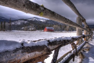 Barn through a fence view. clipart