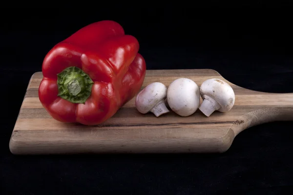 Grönsaker visas på skärbräda. — Stockfoto