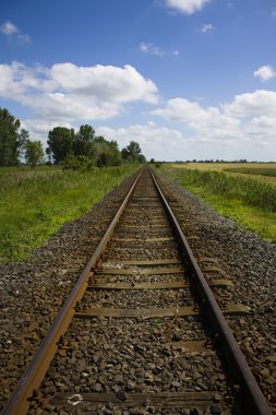 Train tracks disapearing into the countryside clipart