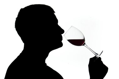 A man in silhouette smelling wine clipart