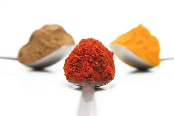 Turmeric, Paprika and Garam masala in a tea spoon — Stock Photo, Image