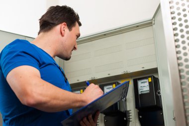Technician reading the electricity meter clipart