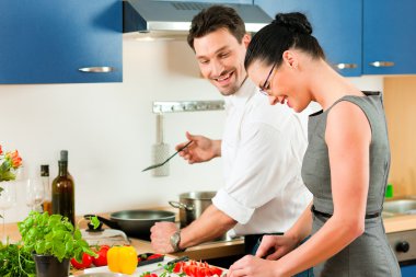 Young couple cooking clipart