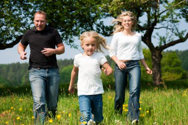 Young family having a walk in clipart