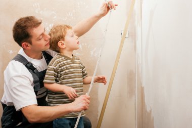 Father and son measuring a dry clipart