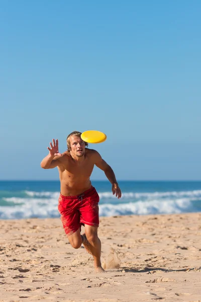 Man on the beach playing — Stock Photo, Image
