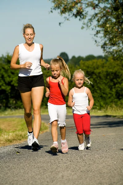 A young mother jogging with — Stock Photo, Image