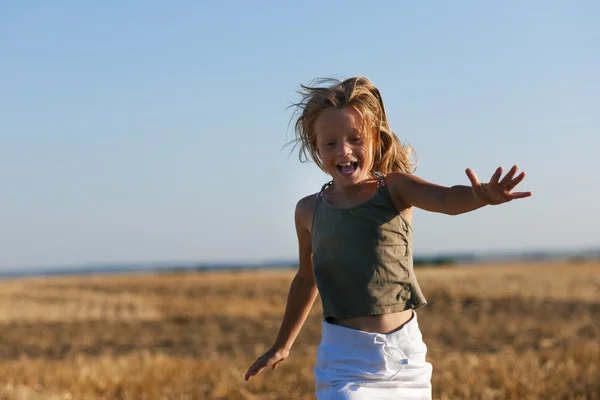 Girl child running over a — Stock Photo, Image