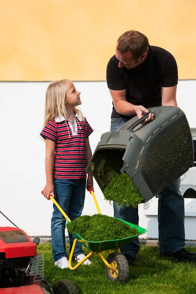 stock image Father and Child mowing the