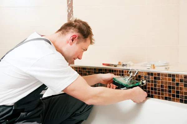 Plumber installing a mixer tap in — Stock Photo, Image