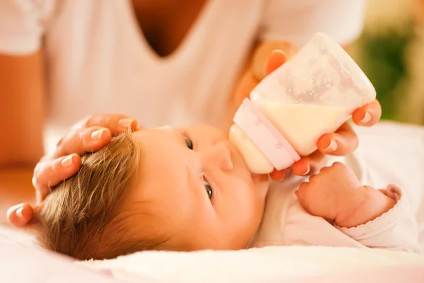 Mother is feeding her baby with — Stock Photo, Image