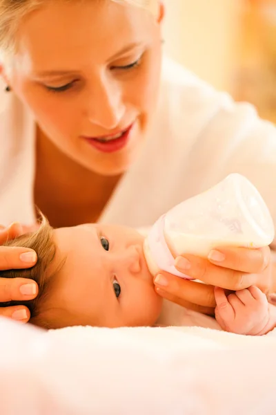 Mother is feeding her baby with — Stock Photo, Image