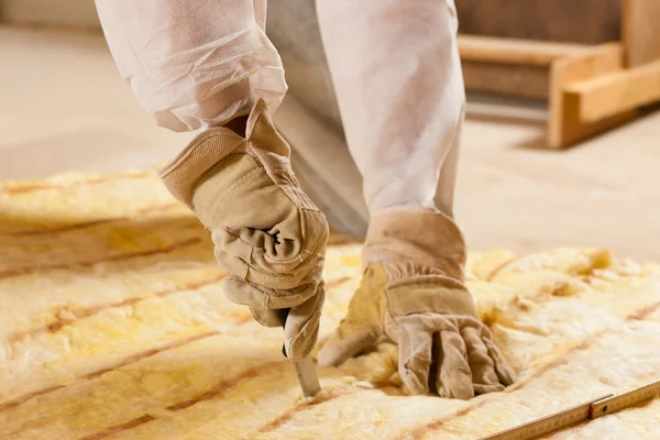 Man cutting insulation material for building — Stock Photo, Image