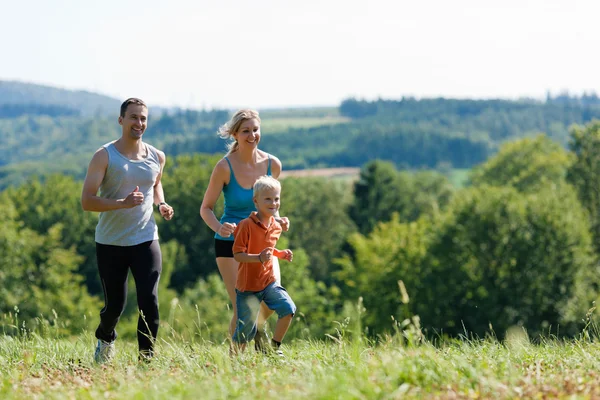 Young family having a walk in — Stock Photo, Image