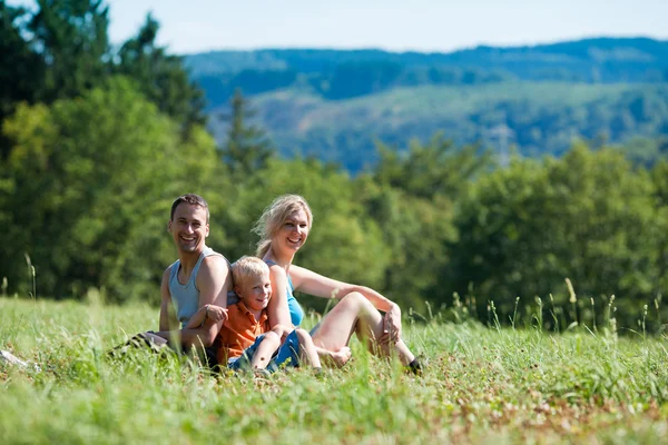 Young family having a walk in — Stock Photo, Image
