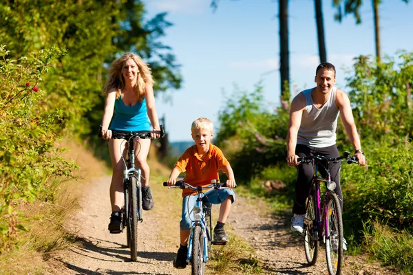 在他们的自行车上儿童的家庭 — 图库照片