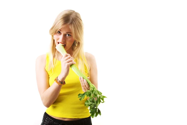 Blond woman in yellow eating — Stock Photo, Image