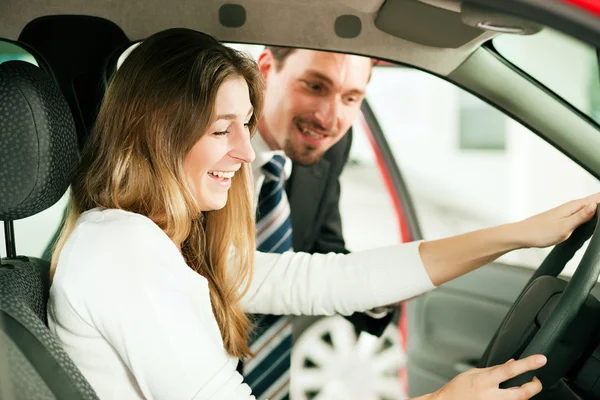 Woman buying a car in Royalty Free Stock Images