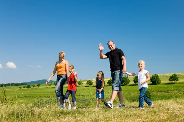 Family in the grass at a Royalty Free Stock Images