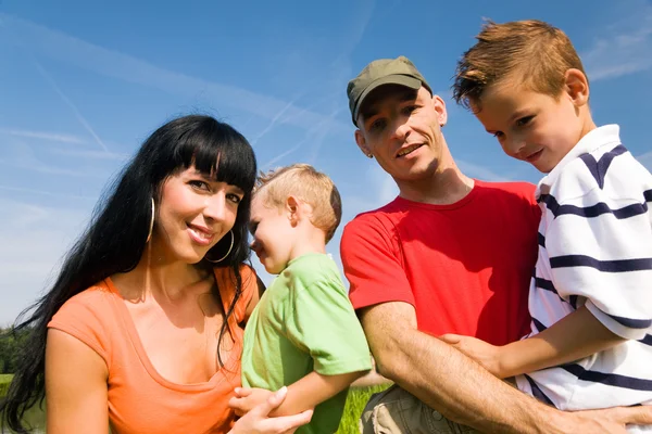 Family in the grass at a Royalty Free Stock Photos