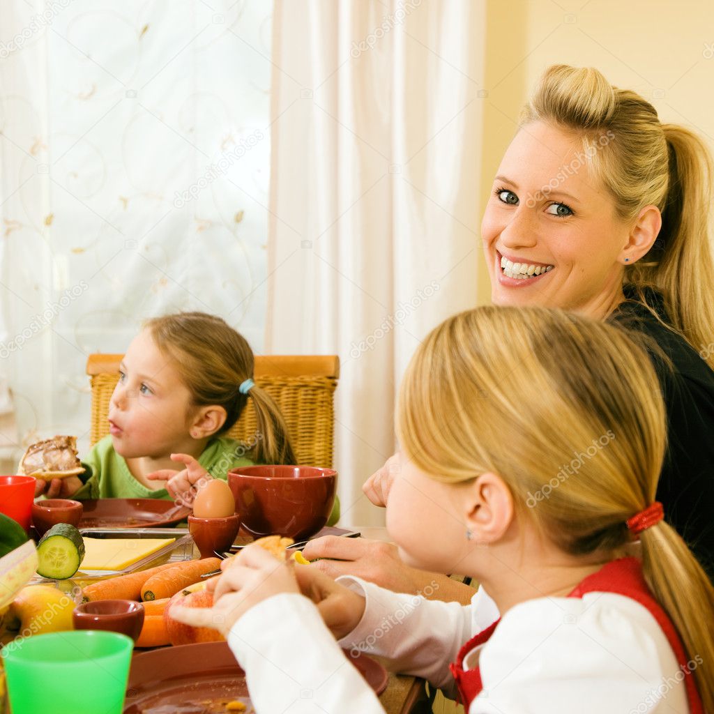 group-of-young-friends-having-dinner-at-home-and-toasting-with-white