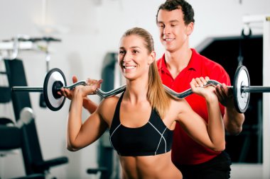 Woman in gym with personal