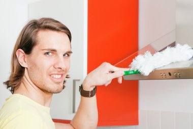 Man dusting his apartment clipart