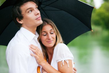 Couple sitting on a lake having clipart