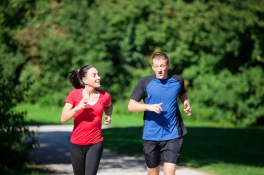 Mature woman is jogging in her clipart