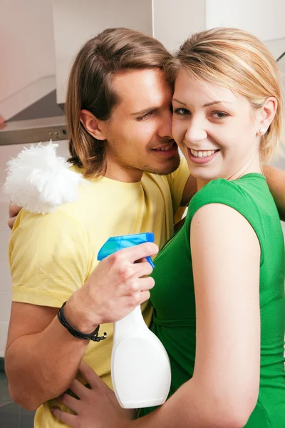 Young couple cleaning their — Stock Photo, Image