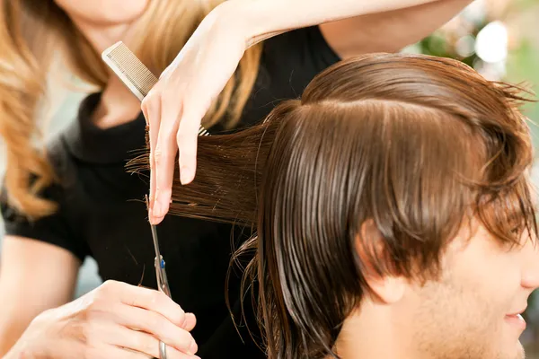 Man at the hairdresser, she is — Stock Photo, Image