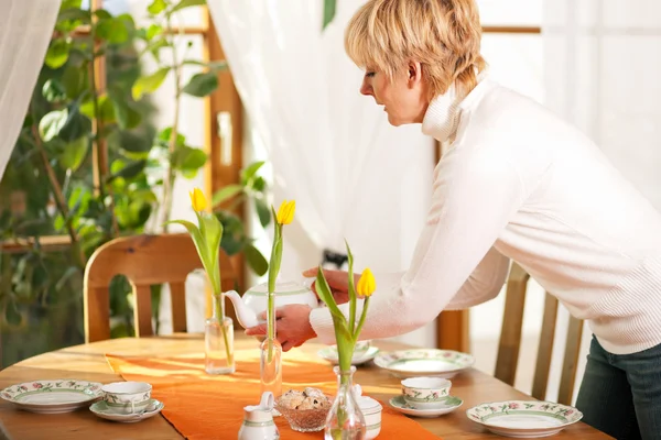 Woman sitting on a table for — Stock Photo, Image