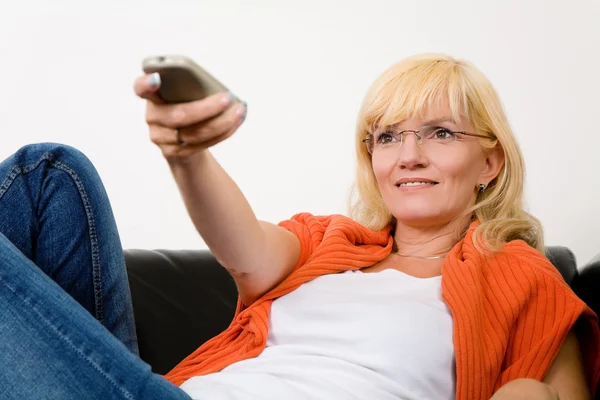 Woman on a sofa with a tv — Stock Photo, Image