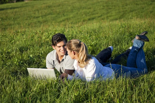 Young couple lying together on — Stock Photo, Image