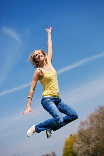Young blonde jumping high up — Stock Photo, Image