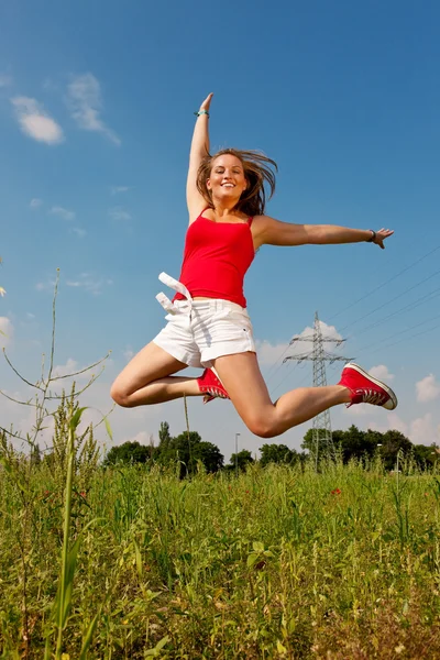 Woman in red t-shirt jumping — Stock Photo, Image