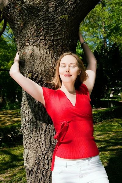 Flicka krama ett träd och — Stockfoto