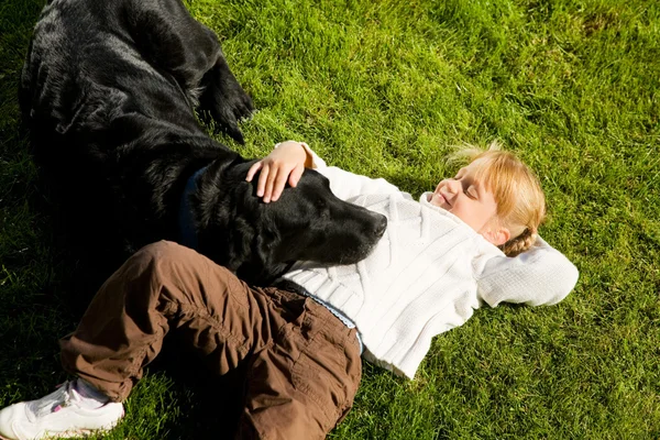 Little girl resting with her dog — Stock Photo, Image