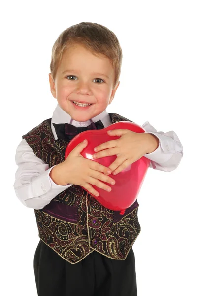 Little boy with red heart-like ballon — Stock Photo, Image