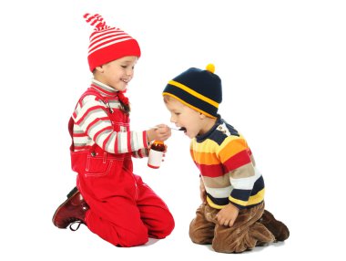 Little boy and smiling girl with spoon and bottle of medicine clipart