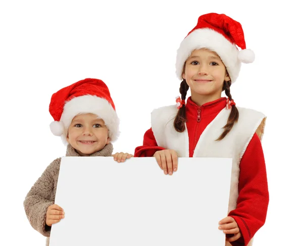Malé děti v vánoční čepice s prázdný nápis — Stock fotografie