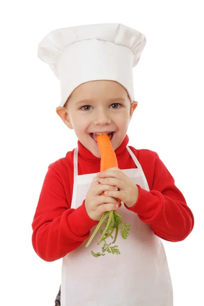 Piccolo capo-cucina sorridente con carota — Foto Stock
