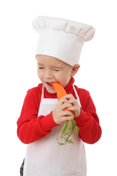 Маленький Шеф Повар Пробует Морковку Изолированную Белом — стоковое фото