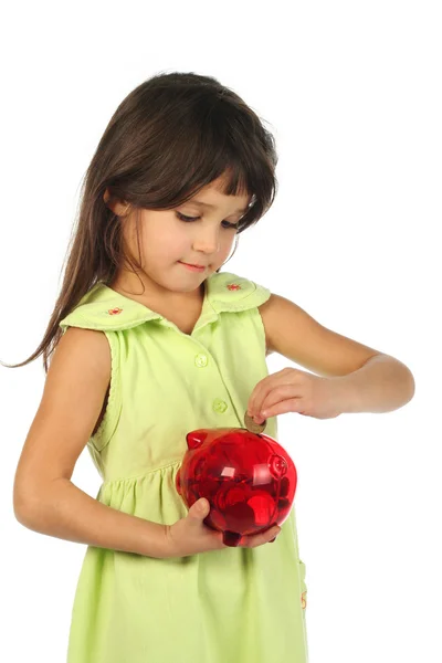 小女孩用红色猪存钱罐 — 图库照片