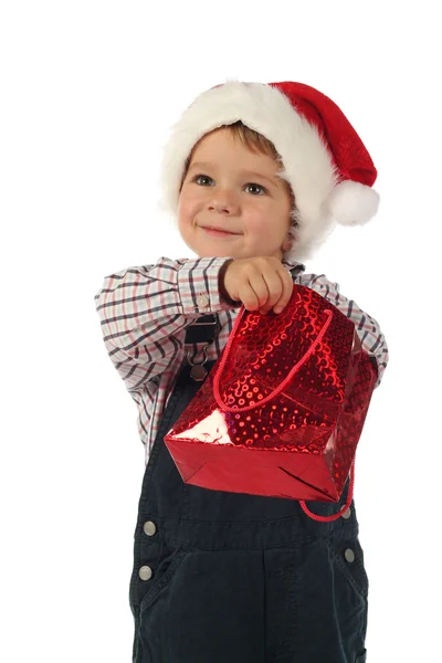 クリスマスのギフト袋で手で小さな男の子の笑みを浮かべてください — ストック写真