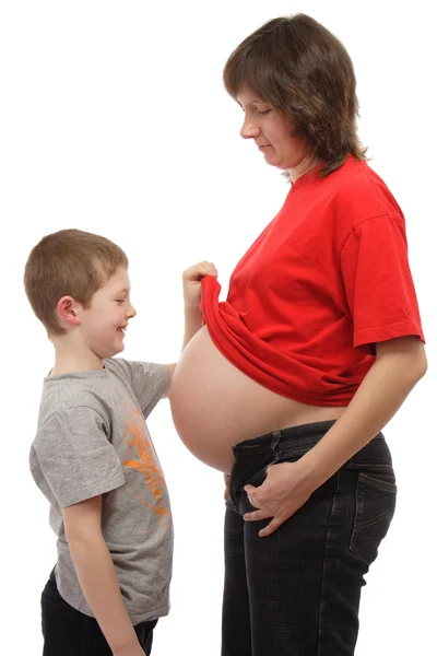 Kind op zoek naar haar zwangere moeders buik — Stockfoto